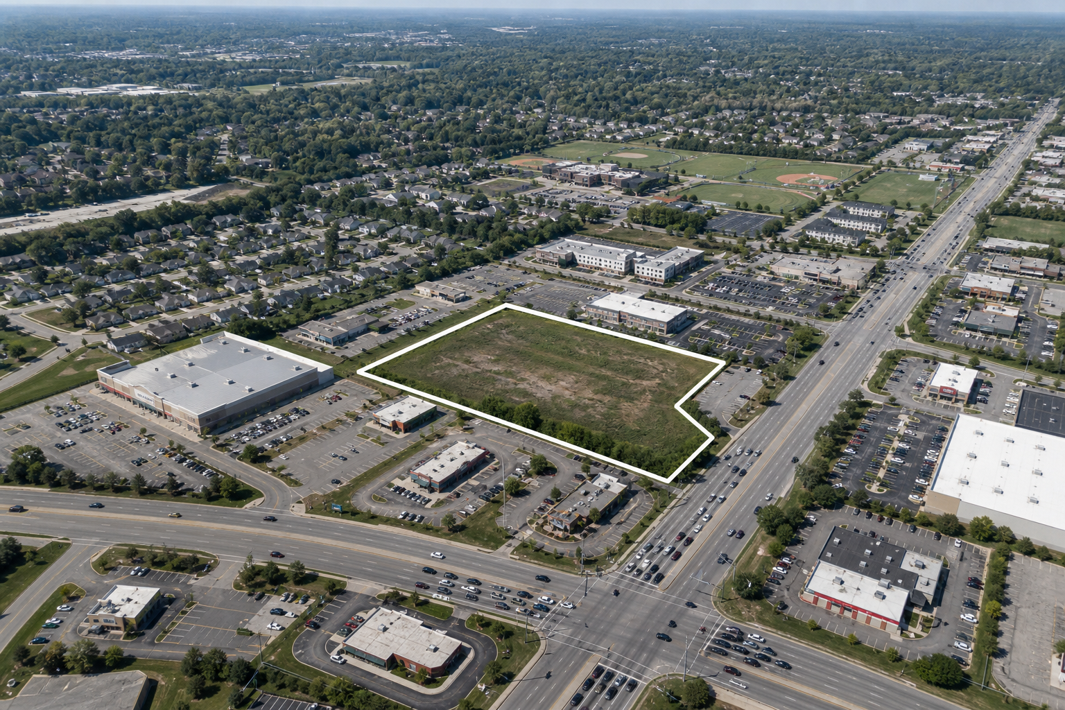Illustrative high-altitude aerial view of a commercial parcel outlined in white
